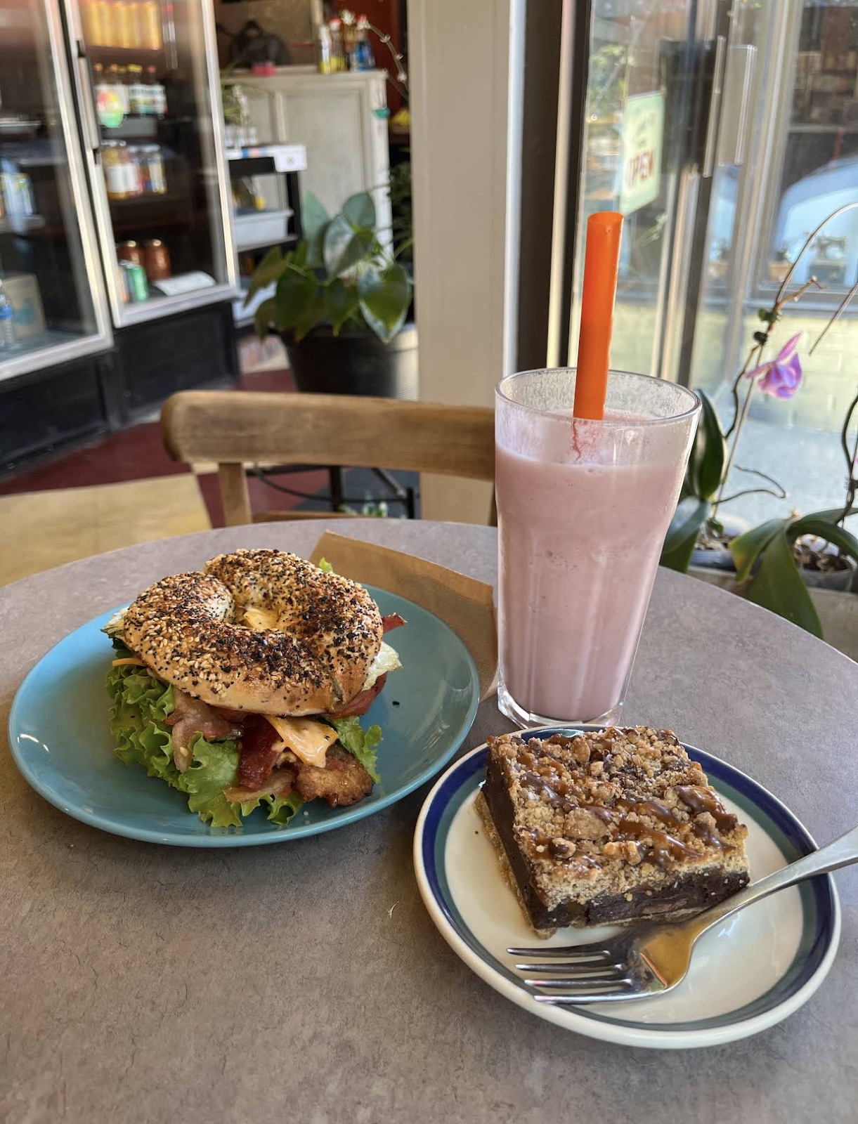 Bagel sandwich smoothie and dessert by the window